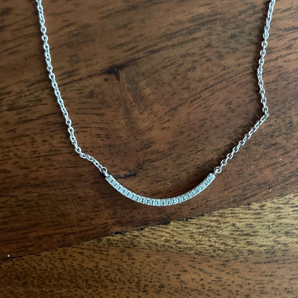 Silver curve with diamond gemstones